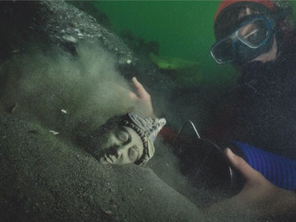 Scuba Diver revealing a Cyprus Statue from 5th BCE. Discovered in Thonis-Heracleion - Cosmopolitan City to Mediterranean Seafarers. ChristophGerigk © Franck Goddio -Hilti Foundation